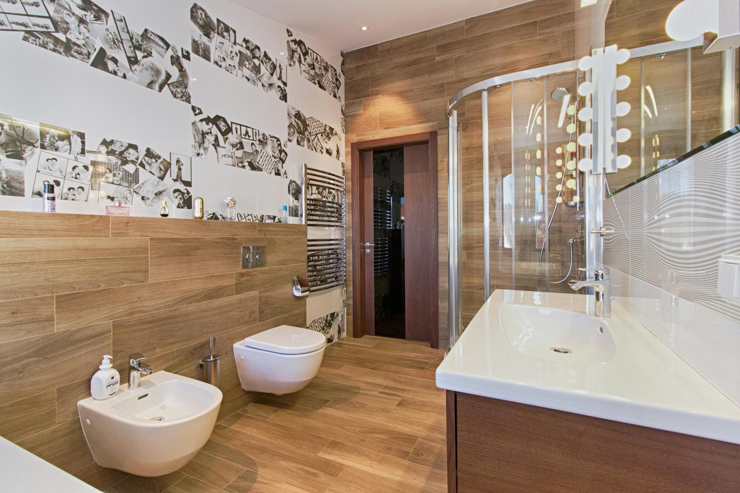 Elegant bathroom featuring wood paneling, modern fixtures, and ample lighting.