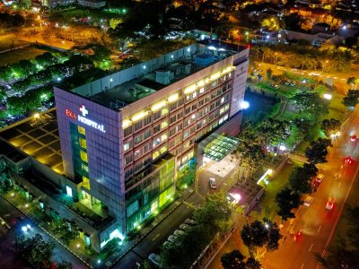 Stunning aerial view of Eka Hospital in Serpong, Indonesia, illuminated at night, capturing vibrant city lights and architecture.