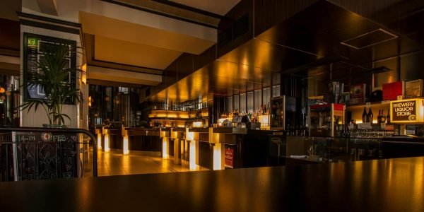 Stylish modern restaurant interior with warm lighting, elegant design, and luxurious ambiance at night.
