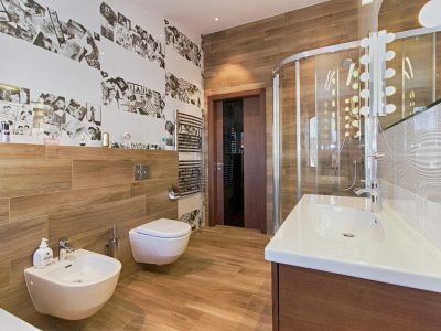 Elegant bathroom featuring wood paneling, modern fixtures, and ample lighting.