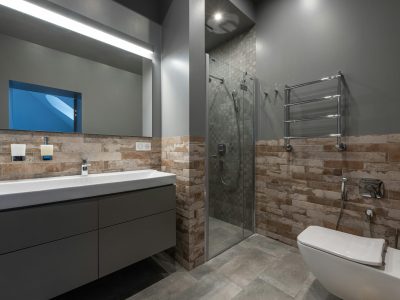 Sleek modern bathroom featuring a glass shower, floating vanity, and stylish decor.